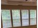 A set of four windows with blinds letting light into the interior of the house at 5669 Avonley Creek Dr, Sugar Hill, GA 30518