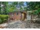 Brick house with fenced-in backyard, stone patio, and natural landscaping at 2875 Monterey Dr, Decatur, GA 30032