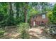 Backyard with wooded surroundings, a multilevel deck, and a brick house with a white door at 2875 Monterey Dr, Decatur, GA 30032