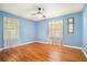 Bright bedroom with blue walls, hardwood floors, and a ceiling fan at 2875 Monterey Dr, Decatur, GA 30032