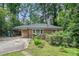 Charming brick home featuring a carport and front yard landscaping at 2875 Monterey Dr, Decatur, GA 30032