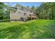 Two-story home with walkout basement and a deck overlooking a large green backyard at 2958 Paul Harris Rd, Dallas, GA 30157