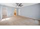 A sizable carpeted primary bedroom with neutral walls and doorways to an ensuite and walk-in closet at 2958 Paul Harris Rd, Dallas, GA 30157