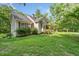 Side view of a well-maintained home with green lawn and mature landscaping at 2958 Paul Harris Rd, Dallas, GA 30157