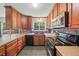 Kitchen featuring updated appliances, custom cabinetry, granite countertops, and tile backsplash at 2958 Paul Harris Rd, Dallas, GA 30157