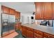 Kitchen featuring stainless appliances, custom cabinetry, updated countertops, and an adjacent living area at 2958 Paul Harris Rd, Dallas, GA 30157