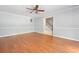 Open living room featuring hardwood floors, crown molding, and access to the staircase at 2958 Paul Harris Rd, Dallas, GA 30157