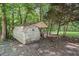Storage shed with a side carport for outdoor storage in a wooded area at 2958 Paul Harris Rd, Dallas, GA 30157