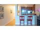 Cozy kitchen with stainless steel appliances and breakfast bar with 2 red chairs at 3338 Peachtree Ne Rd # 1506, Atlanta, GA 30326