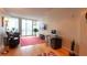 Bright living room with hard wood floors, a desk, and access to a city-view balcony at 3338 Peachtree Ne Rd # 1506, Atlanta, GA 30326