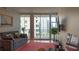 Cozy living room with a sofa, hardwood floors, and city view balcony at 3338 Peachtree Ne Rd # 1506, Atlanta, GA 30326