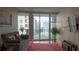 Cozy living room with a sofa, hardwood floors, and city view balcony at 3338 Peachtree Ne Rd # 1506, Atlanta, GA 30326