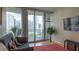 Cozy living room with a sofa, hardwood floors, and city view balcony at 3338 Peachtree Ne Rd # 1506, Atlanta, GA 30326