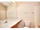 Bathroom featuring a single sink vanity, white toilet and a shower with tile surround at 6344 Wellington Walk Way, Lithonia, GA 30058