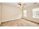 Bedroom featuring neutral carpet, a ceiling fan, and natural light streaming through multiple windows at 6344 Wellington Walk Way, Lithonia, GA 30058