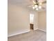 A bedroom with neutral carpet, a ceiling fan, and an open doorway leading to a bathroom area at 6344 Wellington Walk Way, Lithonia, GA 30058