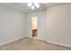 Bedroom with carpet, doorway into ensuite bathroom, and ceiling fan with lighting at 6344 Wellington Walk Way, Lithonia, GA 30058