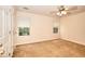 Bedroom with carpet, two windows offering natural light and a ceiling fan at 6344 Wellington Walk Way, Lithonia, GA 30058