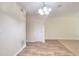 Clean dining area with laminate floors, a chandelier, and neutral paint at 6344 Wellington Walk Way, Lithonia, GA 30058