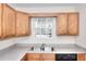 Functional kitchen featuring wood cabinets, neutral countertops, and stainless-steel appliances at 6344 Wellington Walk Way, Lithonia, GA 30058