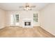 Bright living room featuring carpeted floors, a fireplace, and natural light at 6344 Wellington Walk Way, Lithonia, GA 30058