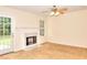 Cozy living room with a marble fireplace, carpeted floors, and ample natural light at 6344 Wellington Walk Way, Lithonia, GA 30058