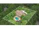 A beautiful property from above, featuring a backyard pool, lush trees and a circular driveway at 7660 Treeridge Ct, Atlanta, GA 30350