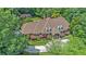 Lushly surrounded estate featuring a brick home with manicured lawns and stately landscaping at 7660 Treeridge Ct, Atlanta, GA 30350