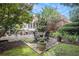 Stone patio with a wrought iron table and chairs surrounded by lush landscaping at 7660 Treeridge Ct, Atlanta, GA 30350