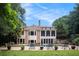 A luxurious backyard with an inground pool, lounge chairs, and manicured landscaping at 7660 Treeridge Ct, Atlanta, GA 30350