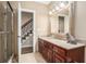Bathroom featuring granite countertops, wood cabinets, shower with glass doors and ornate mirror at 7660 Treeridge Ct, Atlanta, GA 30350