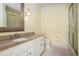 Bright bathroom with a granite vanity, shower with glass door, and neutral color scheme at 7660 Treeridge Ct, Atlanta, GA 30350