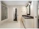 Bathroom featuring a double vanity, framed mirrors, shower with glass doors and tile flooring at 7660 Treeridge Ct, Atlanta, GA 30350