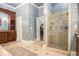 Bathroom featuring a glass-enclosed shower, patterned wallpaper, and a decorative vanity at 7660 Treeridge Ct, Atlanta, GA 30350