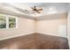 Spacious bedroom featuring hardwood floors, a tray ceiling, and large windows with natural light at 7660 Treeridge Ct, Atlanta, GA 30350