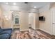 Bonus room with built-in window seats and arches, a television, and hardwood floors at 7660 Treeridge Ct, Atlanta, GA 30350