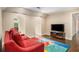 Bonus room with a comfortable sofa, television, and arched window nooks at 7660 Treeridge Ct, Atlanta, GA 30350