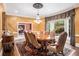 Formal dining room with a chandelier, large window, and elegant table setting for eight at 7660 Treeridge Ct, Atlanta, GA 30350