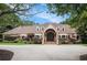 Charming brick home features a symmetrical design with a lush landscaped yard and inviting entrance at 7660 Treeridge Ct, Atlanta, GA 30350