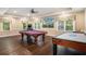 Recreation area includes a pool table, air hockey table, and plenty of space for entertaining at 7660 Treeridge Ct, Atlanta, GA 30350