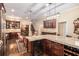 Elegant kitchen with custom dark wood cabinets, a large island with seating, and a wine cooler at 7660 Treeridge Ct, Atlanta, GA 30350