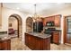 Kitchen featuring a granite countertops, black appliances, custom cabinets, island and tile floor at 7660 Treeridge Ct, Atlanta, GA 30350