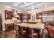 Beautiful kitchen with stainless steel appliances, custom dark wood cabinets, and a large island with bar seating at 7660 Treeridge Ct, Atlanta, GA 30350