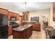Kitchen featuring granite countertops, black appliances, custom cabinets, island and tile floor at 7660 Treeridge Ct, Atlanta, GA 30350