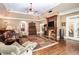Cozy living room with a fireplace, detailed trim, rich hardwood floors, and a large area rug at 7660 Treeridge Ct, Atlanta, GA 30350