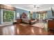 Spacious main bedroom with hardwood floors, large windows offering a view, and ample natural light at 7660 Treeridge Ct, Atlanta, GA 30350