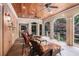Relaxing screened porch with comfortable seating, brick accents, and views of the garden at 7660 Treeridge Ct, Atlanta, GA 30350