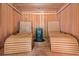 Interior of a cedar sauna with wood plank benches and a center heating unit at 7660 Treeridge Ct, Atlanta, GA 30350