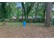 A spacious backyard with a large tree and scattered debris, offering privacy in a serene setting at 1377 Tucker Woods Dr, Norcross, GA 30093