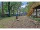 View of the backyard featuring trees and a deck with stairs, complementing the property's exterior at 1377 Tucker Woods Dr, Norcross, GA 30093